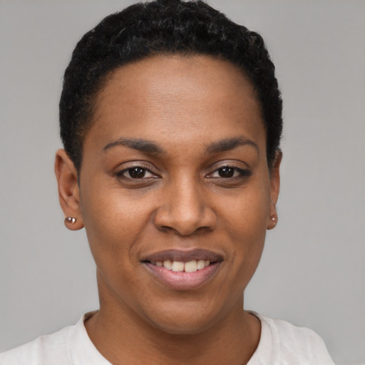 Joyful black young-adult female with short  black hair and brown eyes