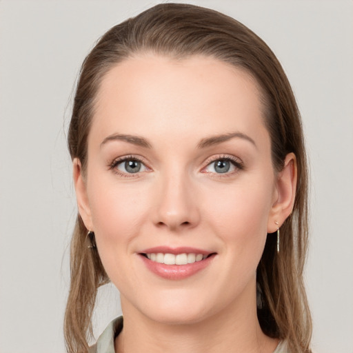 Joyful white young-adult female with long  brown hair and grey eyes