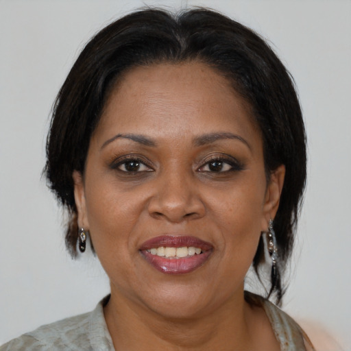 Joyful latino adult female with medium  brown hair and brown eyes