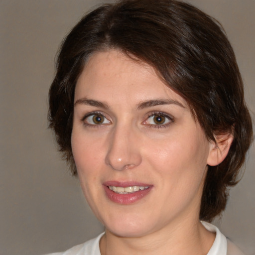 Joyful white young-adult female with medium  brown hair and brown eyes