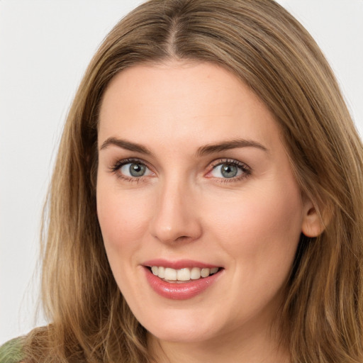 Joyful white young-adult female with long  brown hair and green eyes