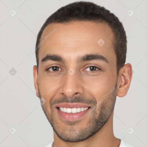 Joyful white young-adult male with short  black hair and brown eyes