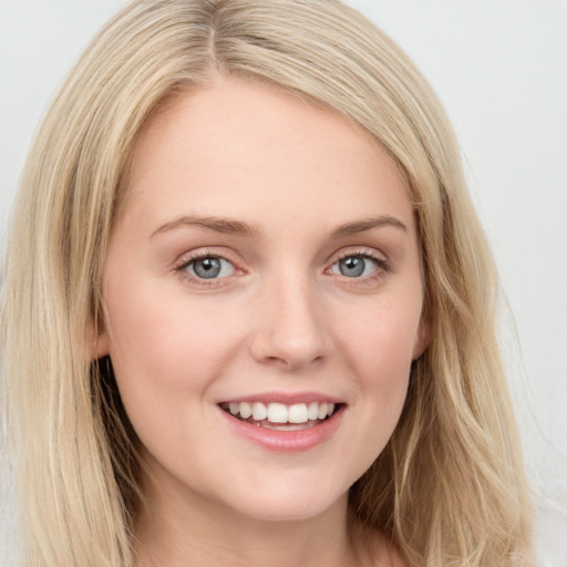 Joyful white young-adult female with long  brown hair and blue eyes