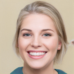 Joyful white young-adult female with medium  brown hair and blue eyes