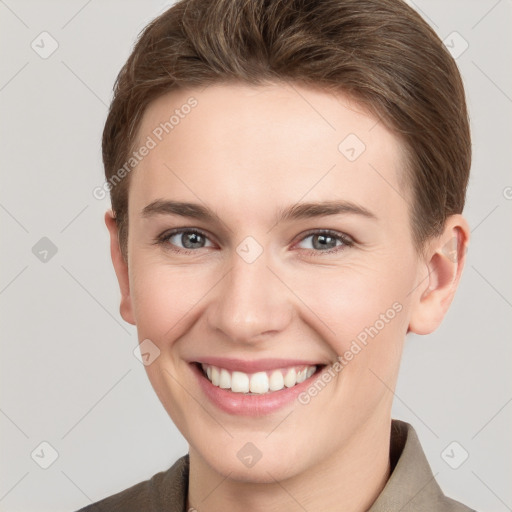 Joyful white young-adult female with short  brown hair and grey eyes