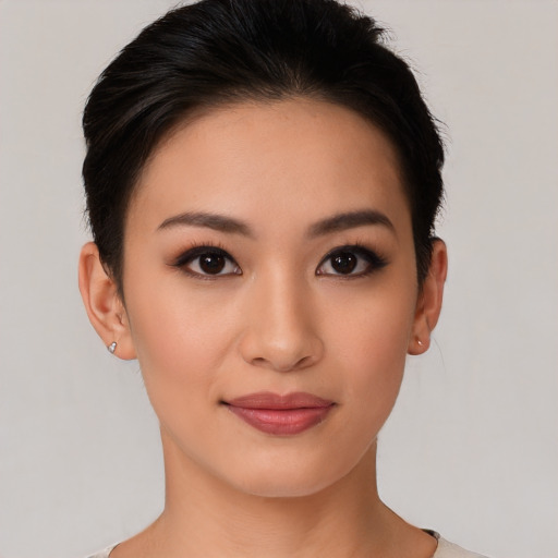 Joyful asian young-adult female with short  black hair and brown eyes