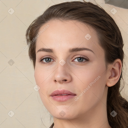 Joyful white young-adult female with medium  brown hair and green eyes