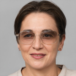 Joyful white adult female with medium  brown hair and brown eyes