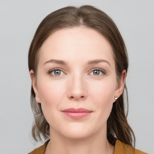 Joyful white young-adult female with medium  brown hair and grey eyes