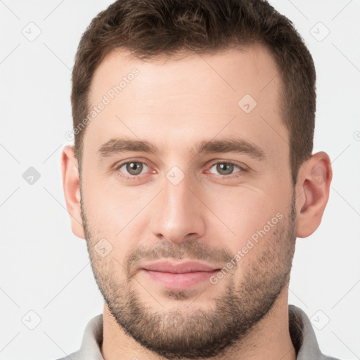 Joyful white young-adult male with short  brown hair and brown eyes