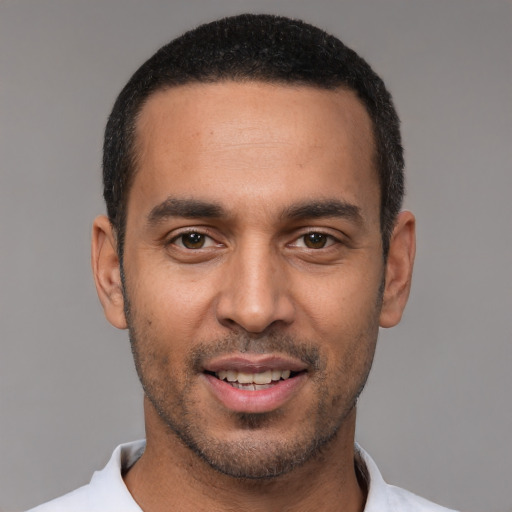 Joyful white young-adult male with short  black hair and brown eyes