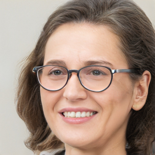 Joyful white adult female with long  brown hair and brown eyes