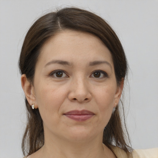 Joyful white adult female with medium  brown hair and brown eyes