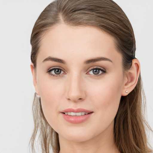 Joyful white young-adult female with long  brown hair and blue eyes