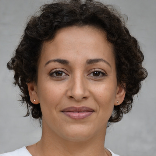 Joyful white adult female with medium  brown hair and brown eyes