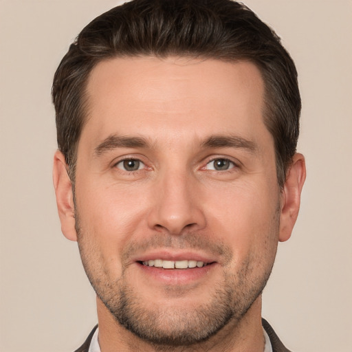 Joyful white young-adult male with short  brown hair and brown eyes