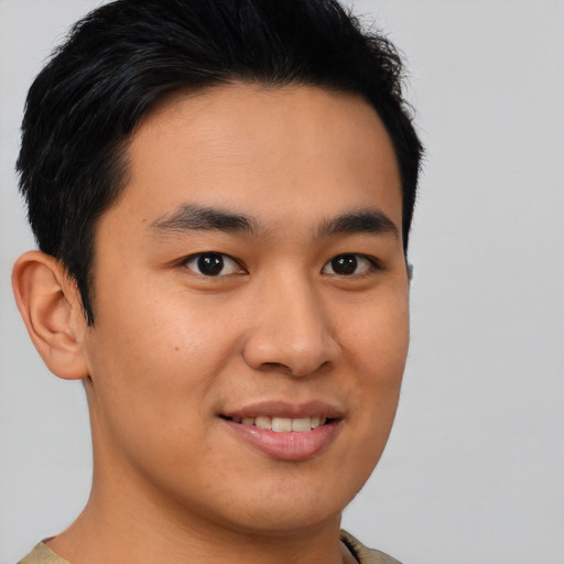 Joyful asian young-adult male with short  brown hair and brown eyes