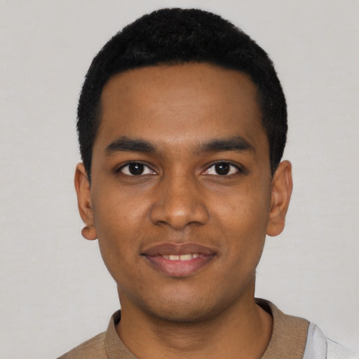 Joyful black young-adult male with short  black hair and brown eyes
