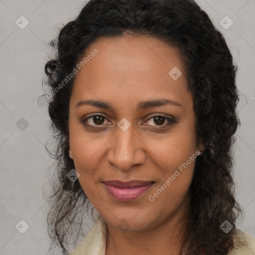 Joyful black adult female with long  brown hair and brown eyes