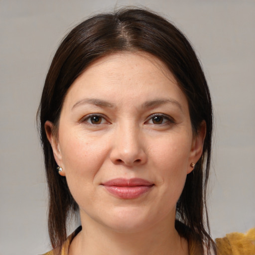 Joyful white young-adult female with medium  brown hair and brown eyes