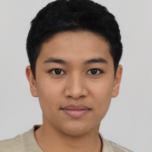 Joyful latino young-adult male with short  black hair and brown eyes