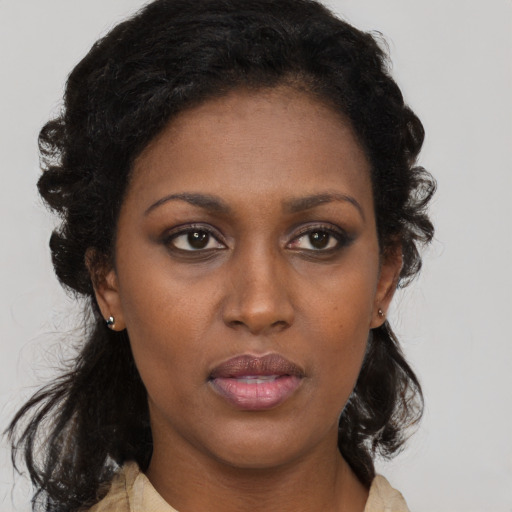 Neutral black young-adult female with medium  brown hair and brown eyes