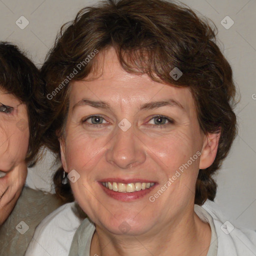 Joyful white adult female with medium  brown hair and blue eyes