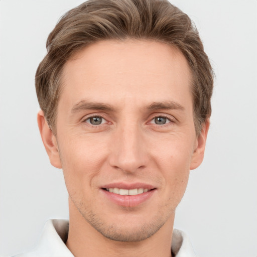 Joyful white adult male with short  brown hair and grey eyes