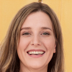 Joyful white young-adult female with long  brown hair and green eyes