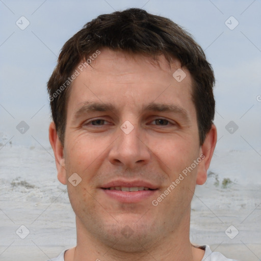 Joyful white adult male with short  brown hair and brown eyes