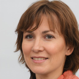 Joyful white adult female with medium  brown hair and brown eyes