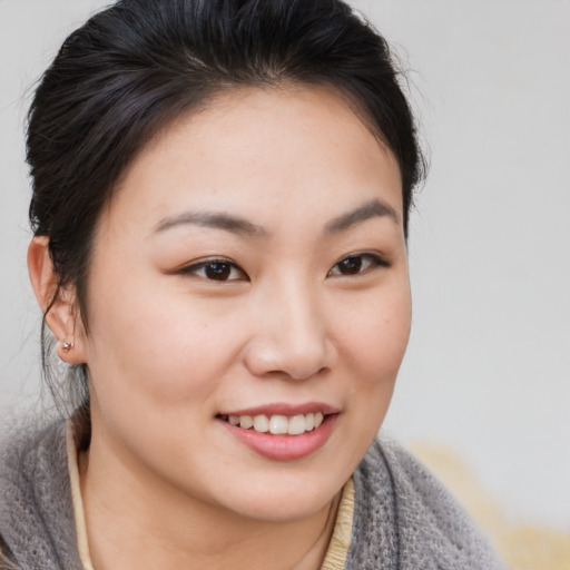 Joyful asian young-adult female with medium  brown hair and brown eyes