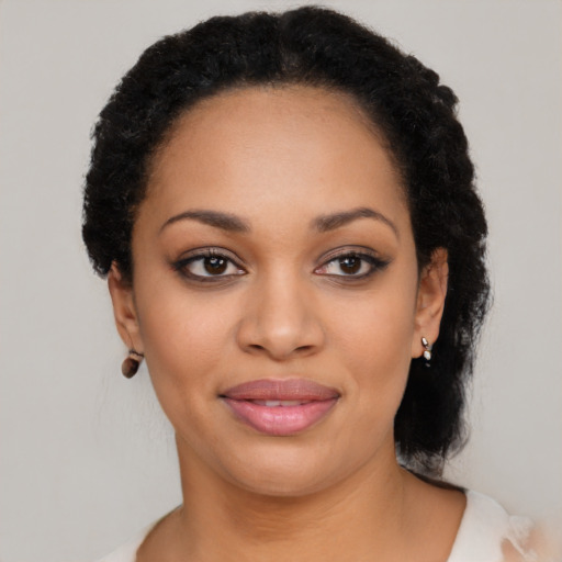 Joyful black young-adult female with medium  black hair and brown eyes