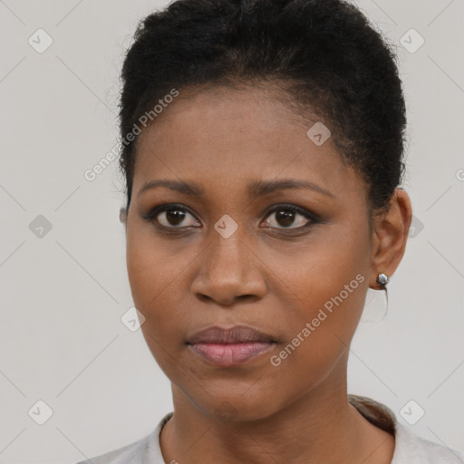 Joyful black young-adult female with short  brown hair and brown eyes