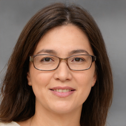 Joyful white adult female with medium  brown hair and brown eyes