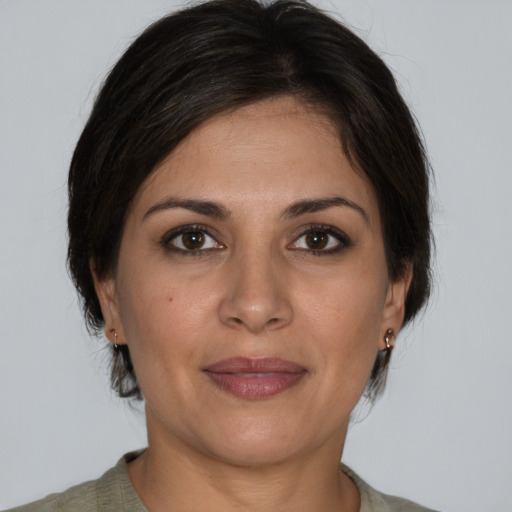 Joyful white adult female with medium  brown hair and brown eyes
