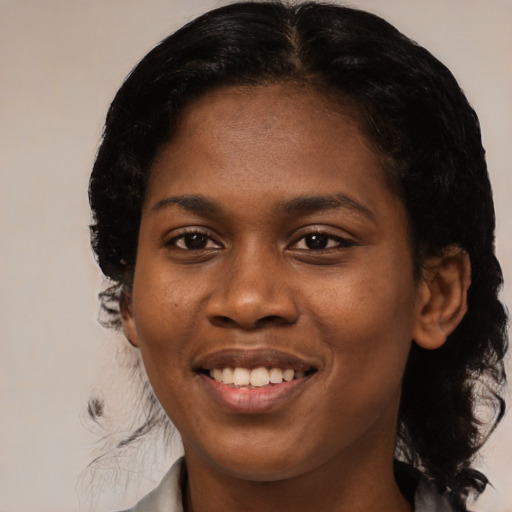 Joyful black young-adult female with medium  black hair and brown eyes