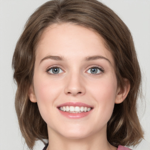 Joyful white young-adult female with medium  brown hair and green eyes