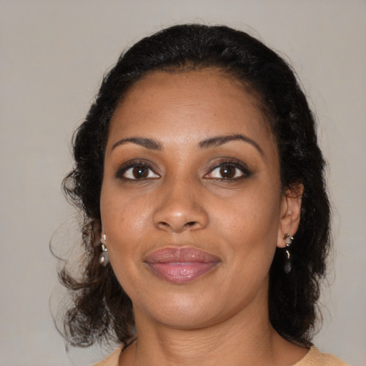 Joyful black young-adult female with medium  black hair and brown eyes