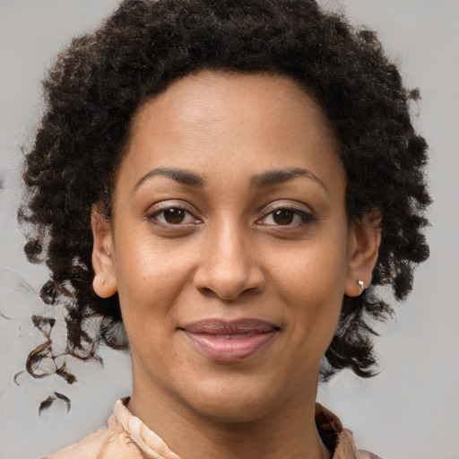 Joyful black young-adult female with medium  brown hair and brown eyes