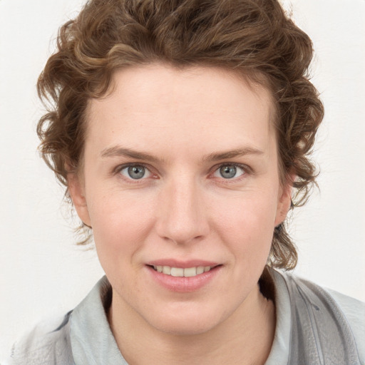 Joyful white young-adult female with medium  brown hair and blue eyes