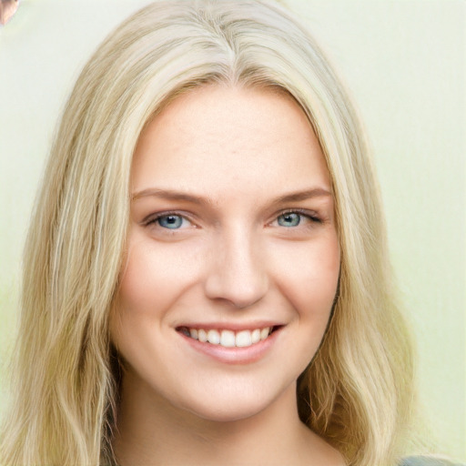 Joyful white young-adult female with long  blond hair and blue eyes