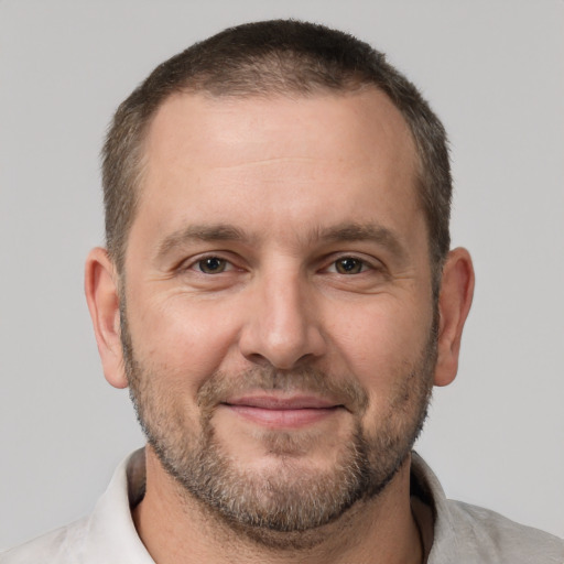 Joyful white adult male with short  brown hair and brown eyes