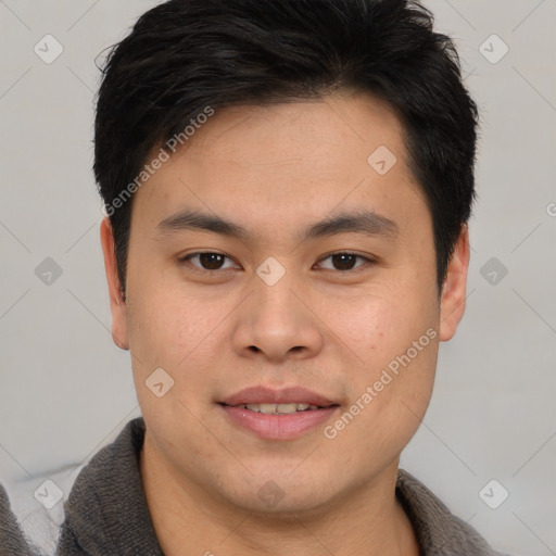 Joyful asian young-adult male with short  brown hair and brown eyes