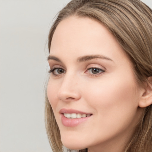 Joyful white young-adult female with long  brown hair and grey eyes