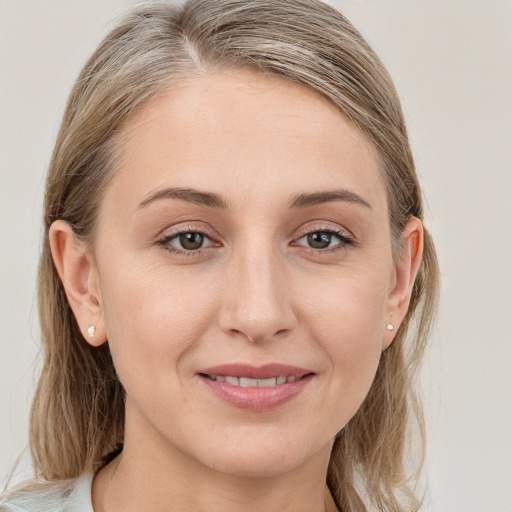 Joyful white young-adult female with medium  brown hair and blue eyes