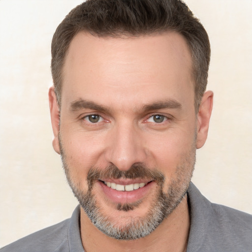 Joyful white adult male with short  brown hair and brown eyes