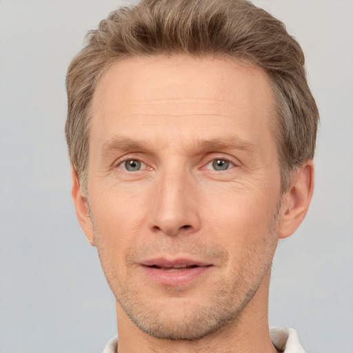 Joyful white adult male with short  brown hair and grey eyes