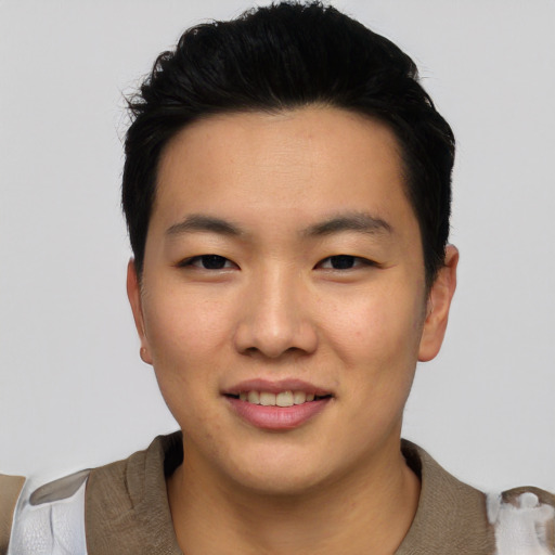 Joyful asian young-adult male with short  black hair and brown eyes