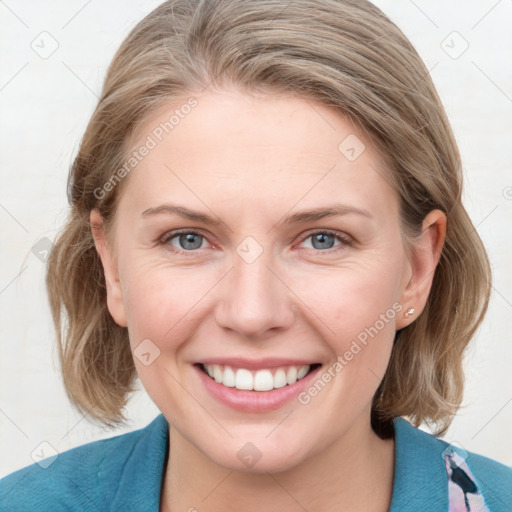 Joyful white young-adult female with medium  brown hair and blue eyes